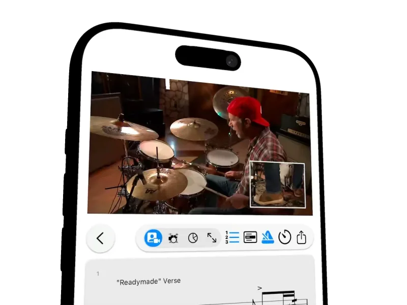 Drumr on iPhone: Chad Smith teaches how to play the verse of Readymade in a lesson video, with an inset close-up of the bass drum pedal, above the notation as the cursor follows each note